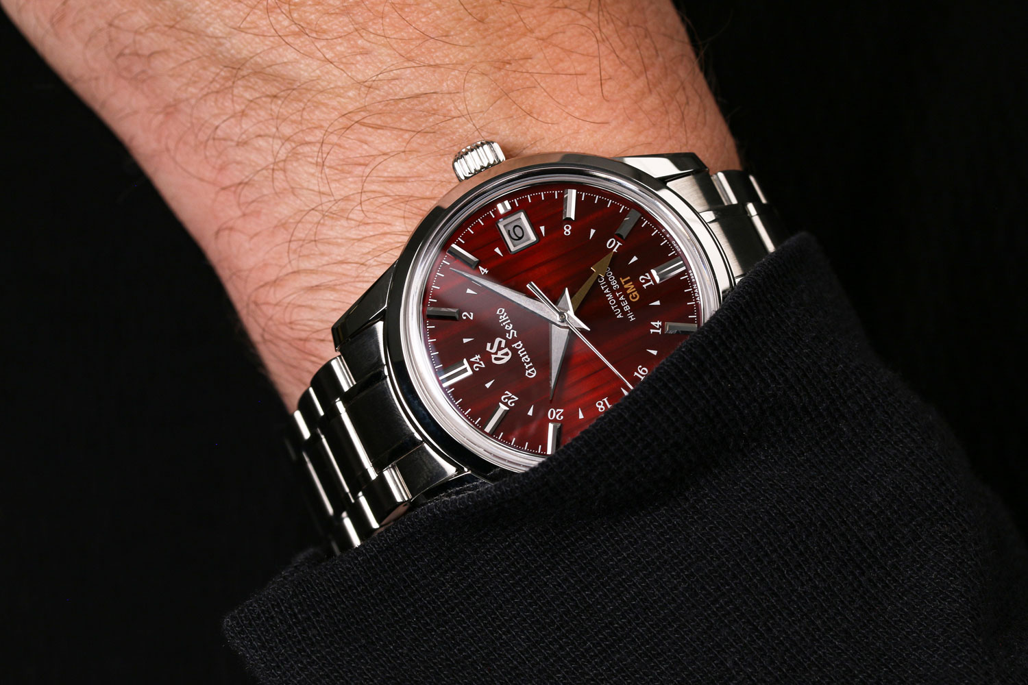 Grand Seiko SBGJ273 red dial watch on wrist.